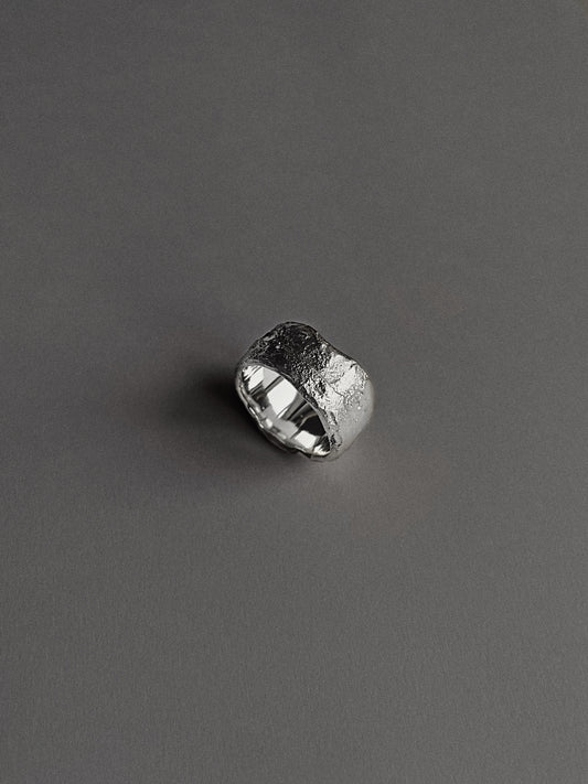 a wide and heavy textured ring
